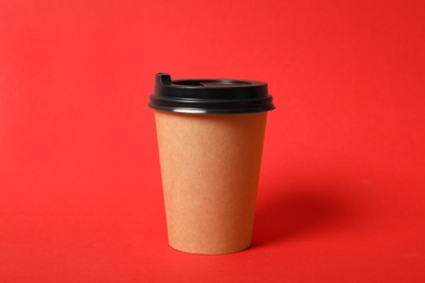 Photo of Takeaway paper coffee cup on red background