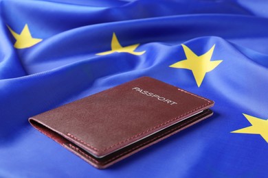 Immigration to Europe. Passport on flag, closeup