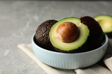 Photo of Delicious ripe avocados on grey marble table