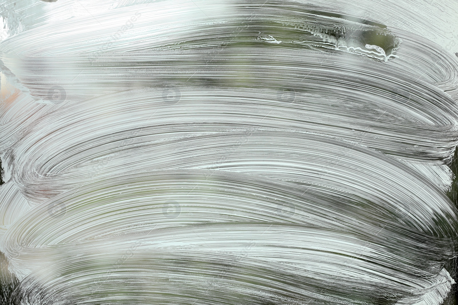 Photo of Cleaning foam on window glass, closeup view