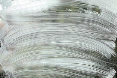 Cleaning foam on window glass, closeup view