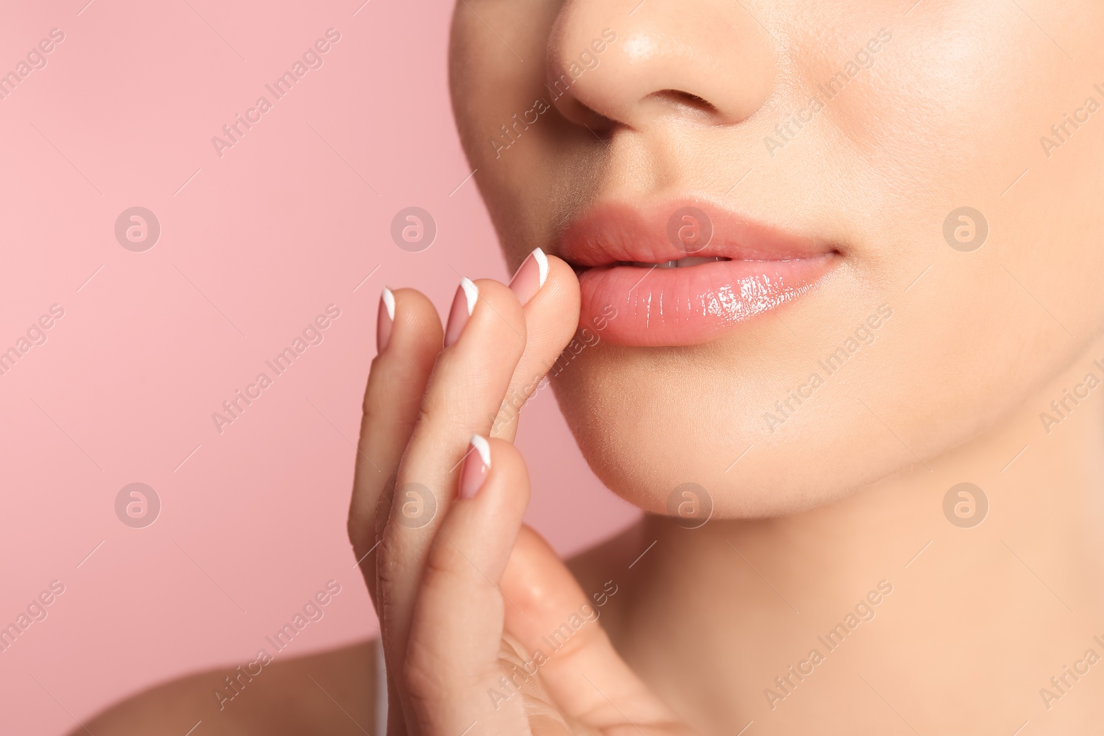 Photo of Young woman with sexy lips on color background, closeup