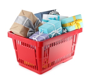 Photo of Red shopping basket with different gifts on white background