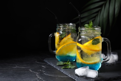 Photo of Delicious refreshing drink on black table. Space for text