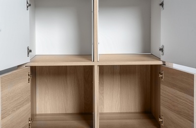 Photo of Empty wardrobe compartments, closeup view. Stylish furniture