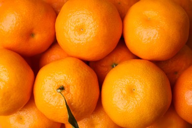 Photo of Heap of fresh juicy tangerines as background, top view