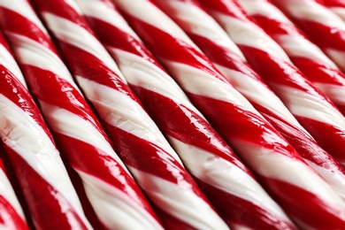 Photo of Candy canes as background, closeup. Traditional Christmas treat