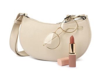 Photo of Stylish baguette bag with glasses and lipstick isolated on white