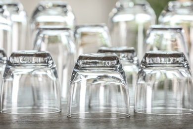 Photo of Set of empty glasses on wooden table, closeup