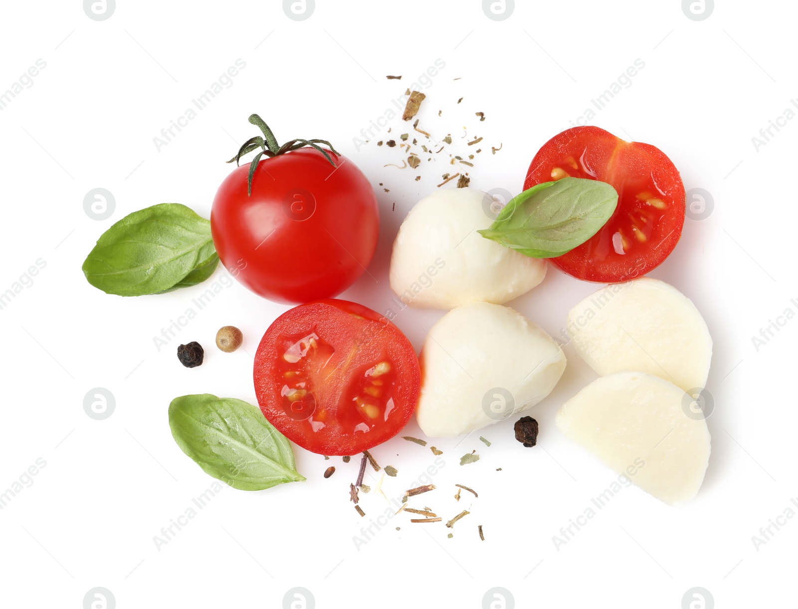 Photo of Delicious mozzarella with tomatoes and basil leaves on white background, top view