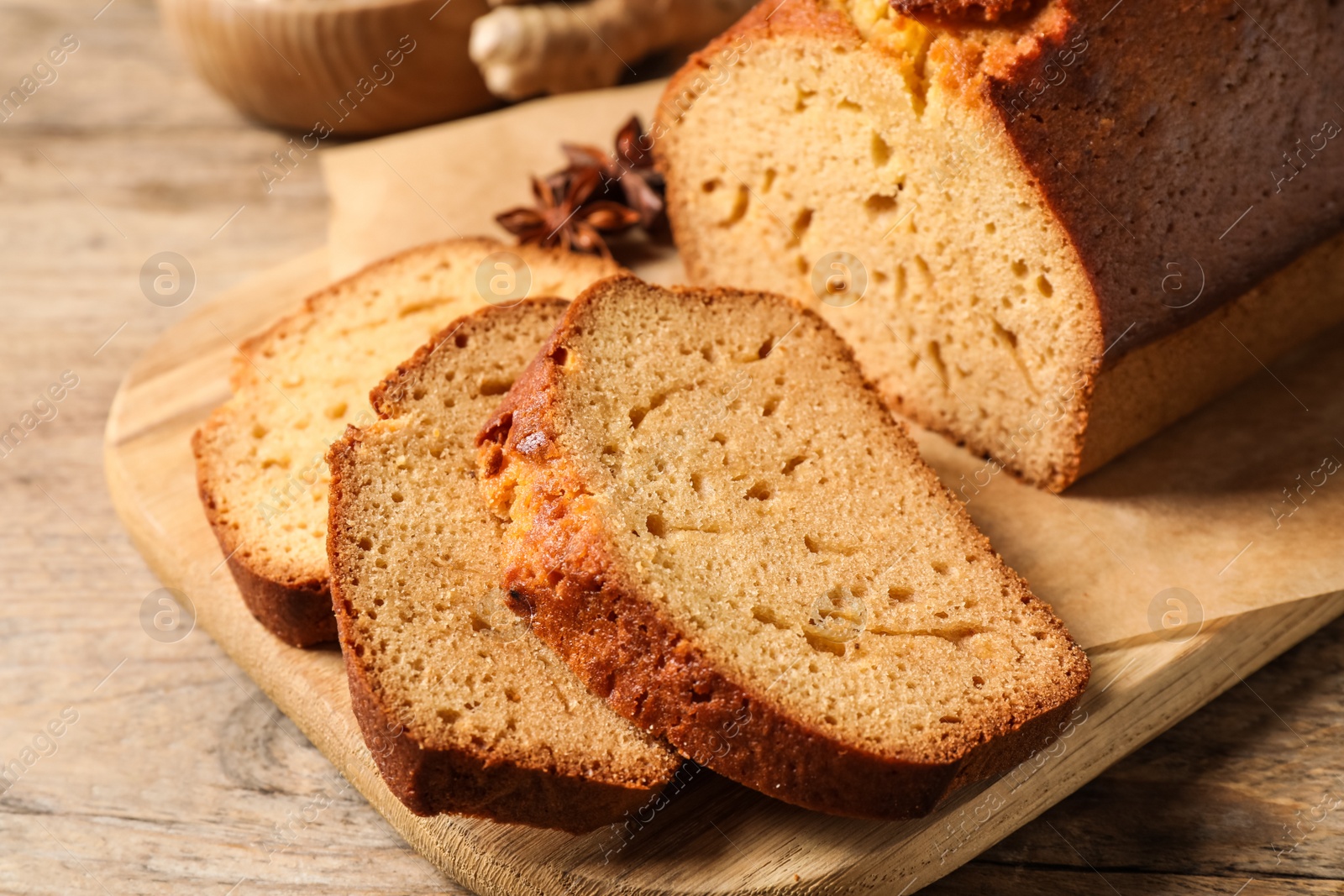 Photo of Sliced delicious gingerbread cake on wooden table, closeup