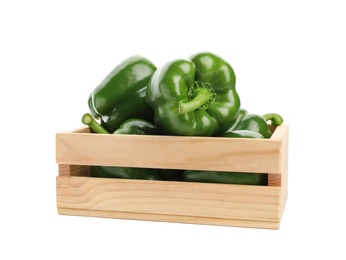 Wooden crate with ripe green bell peppers on white background