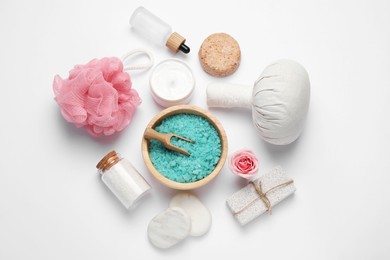 Photo of Beautiful spa composition with herbal massage bag and different care products on white background, flat lay