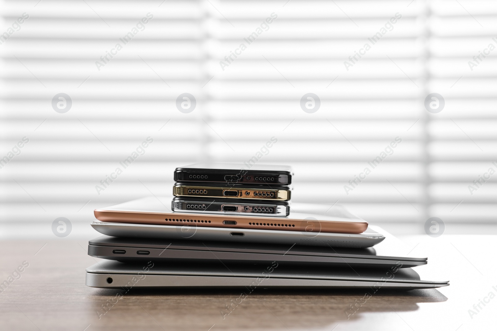 Photo of Many different modern gadgets on wooden table indoors. Space for text