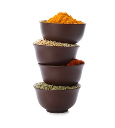 Stack of bowls with different aromatic spices on white background