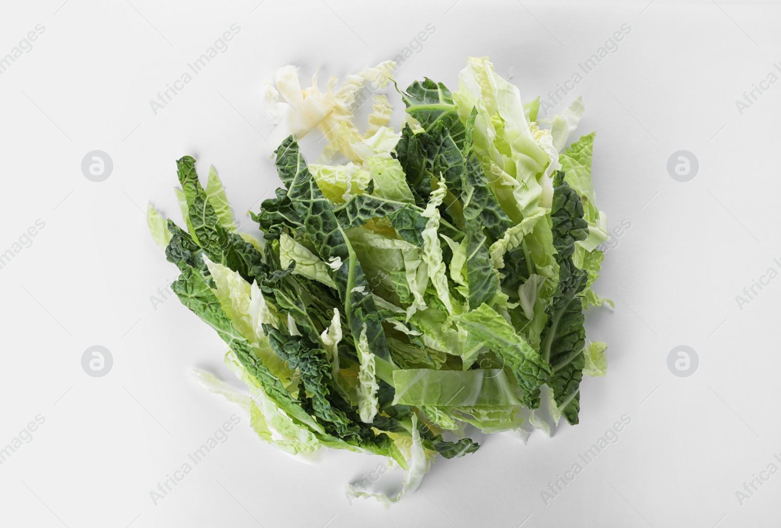 Photo of Pile of chopped fresh green savoy cabbage on white background, top view