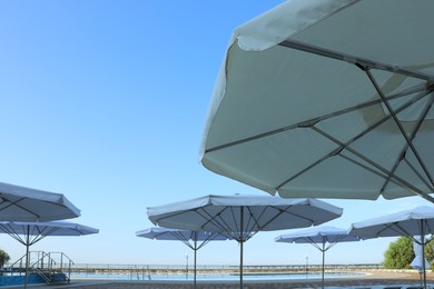 Beach umbrellas near outdoor swimming pool at resort