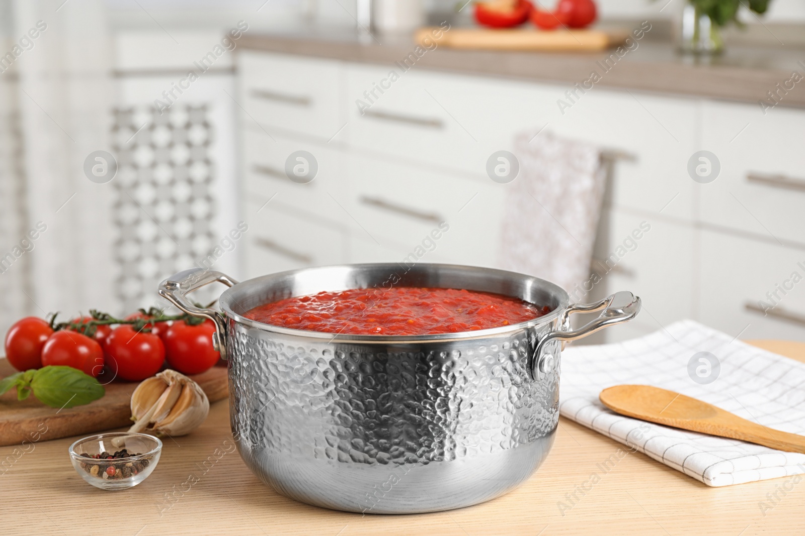 Photo of Fresh delicious tomato sauce on wooden table