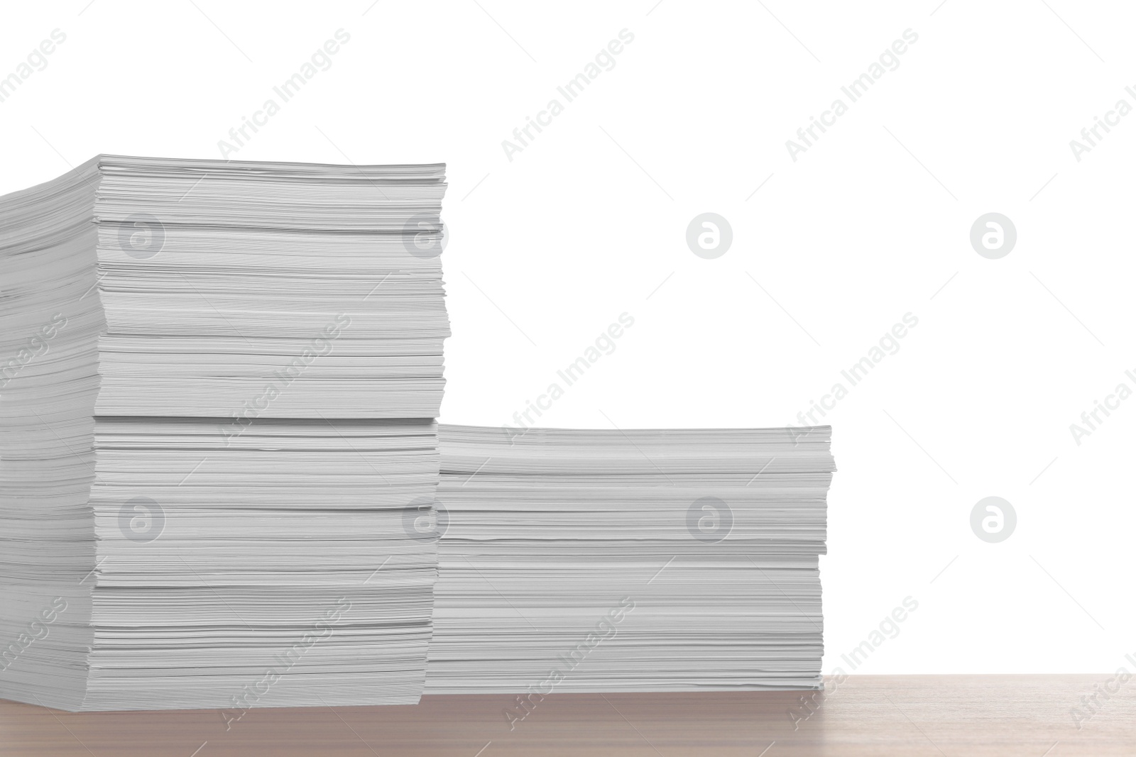 Photo of Stacks of paper sheets on wooden table against white background. Space for text