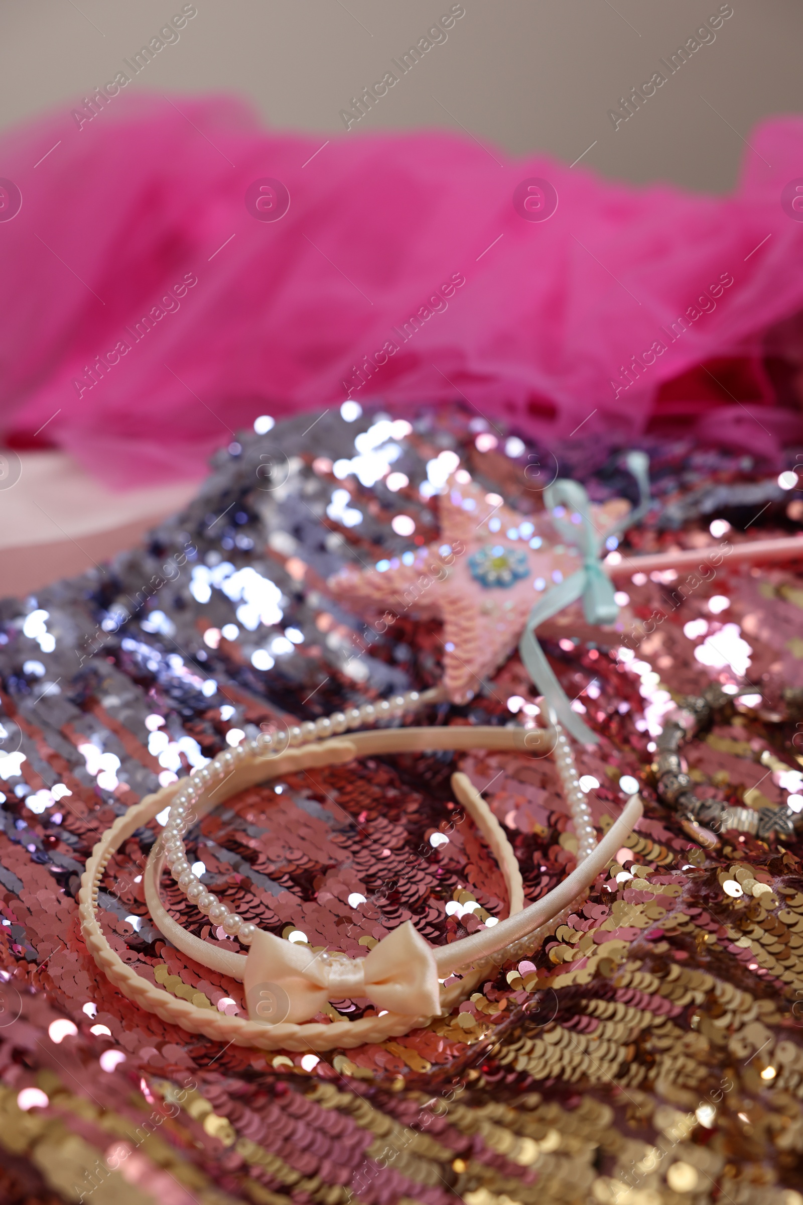 Photo of Stylish carnival costume with sequins, wand and headbands, closeup