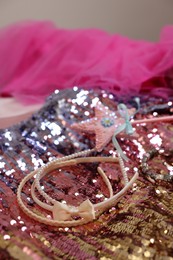 Photo of Stylish carnival costume with sequins, wand and headbands, closeup