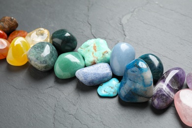 Row of different beautiful gemstones on grey background