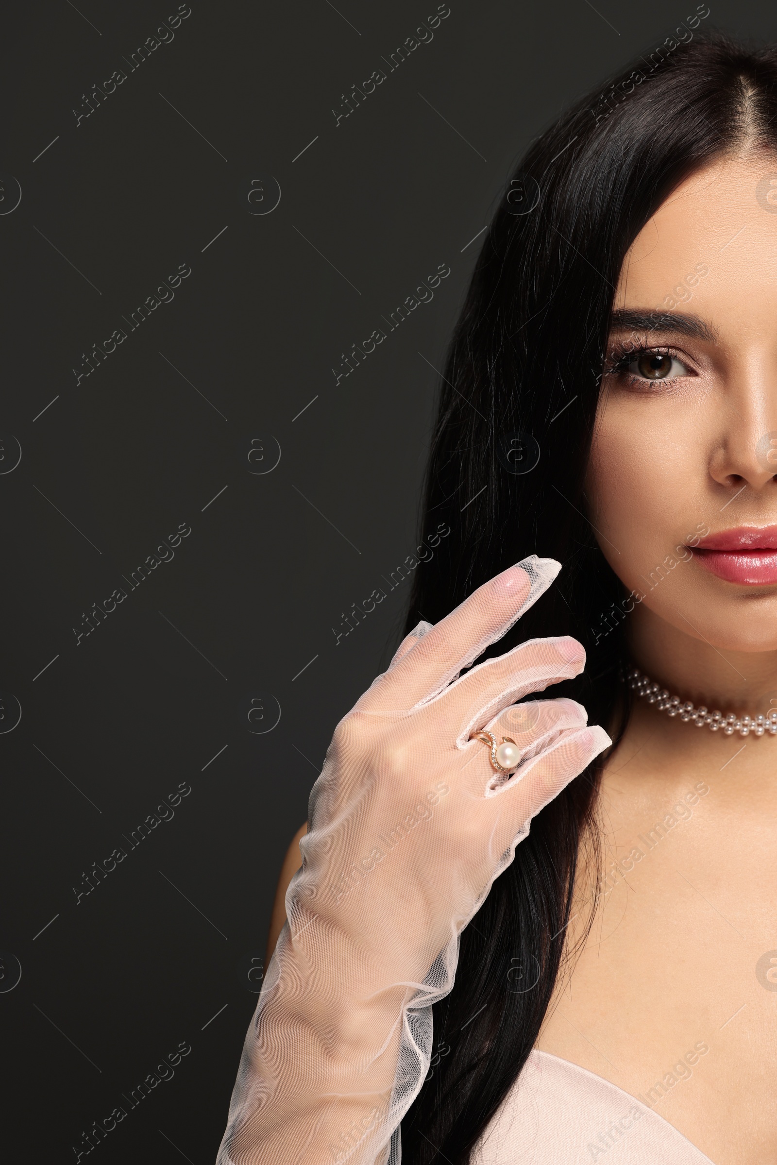 Photo of Young woman with beautiful makeup on black background, closeup