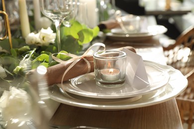 Photo of Elegant table setting with beautiful floral decor and burning candle