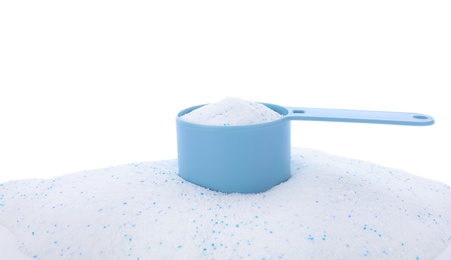 Measuring spoon with laundry powder on white background