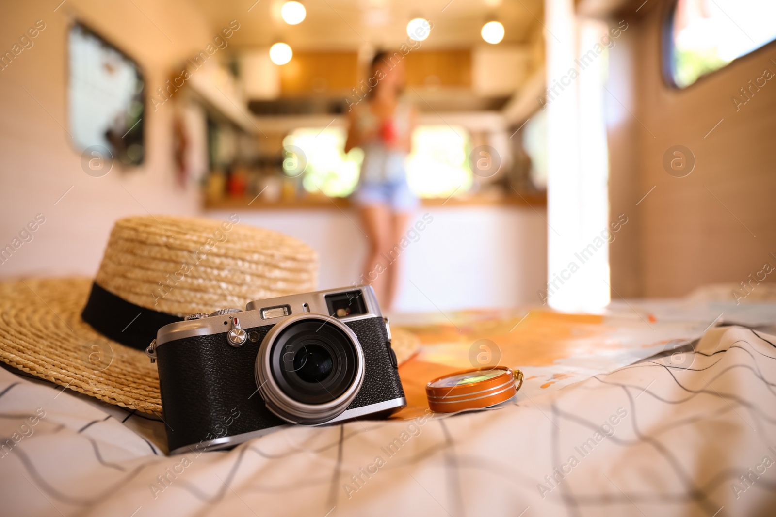 Photo of Composition with travel accessories on bed in motorhome, closeup. Summer trip