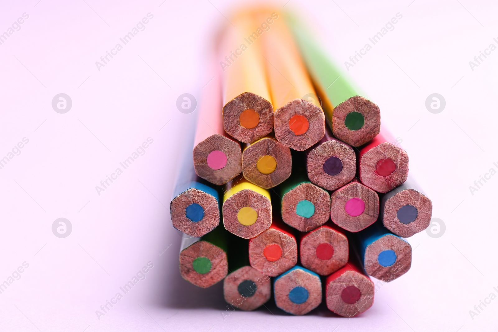 Photo of Different color pencils on light background, closeup