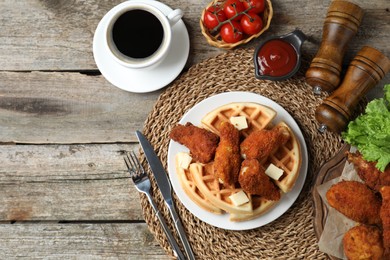 Photo of Delicious Belgium waffles served with fried chicken and butter on wooden table, flat lay. Space for text