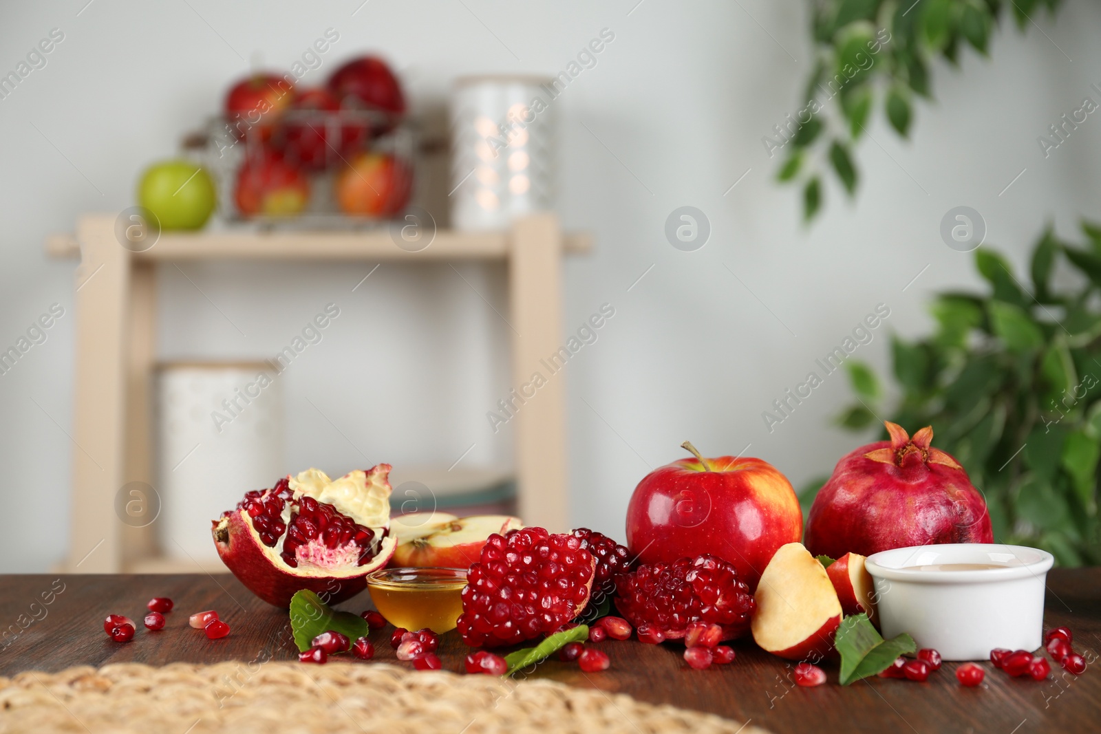 Photo of Honey, apples and pomegranate on wooden table. Rosh Hashanah holiday