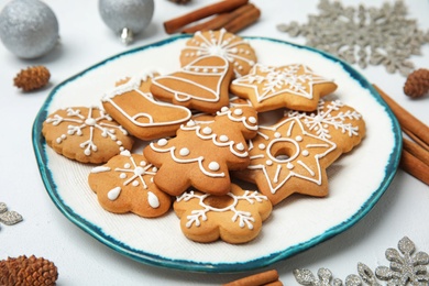 Photo of Plate with tasty homemade Christmas cookies on table