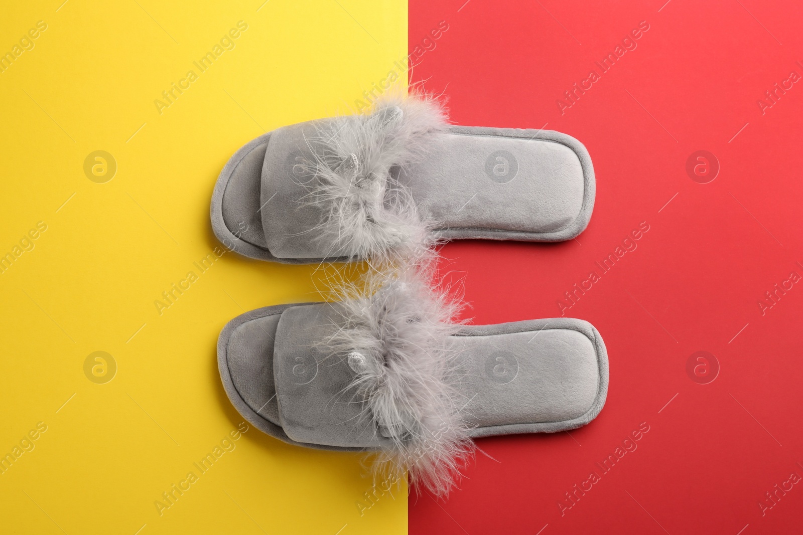 Photo of Pair of stylish soft slippers on color background, flat lay