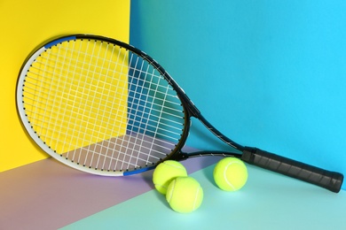 Photo of Tennis racket and balls on color background. Sports equipment