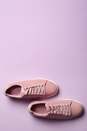 Photo of Bright stylish shoes on color background, top view. Space for text