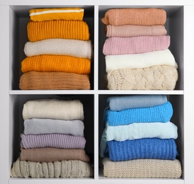 Many knitted winter clothes stacked on shelves on white background