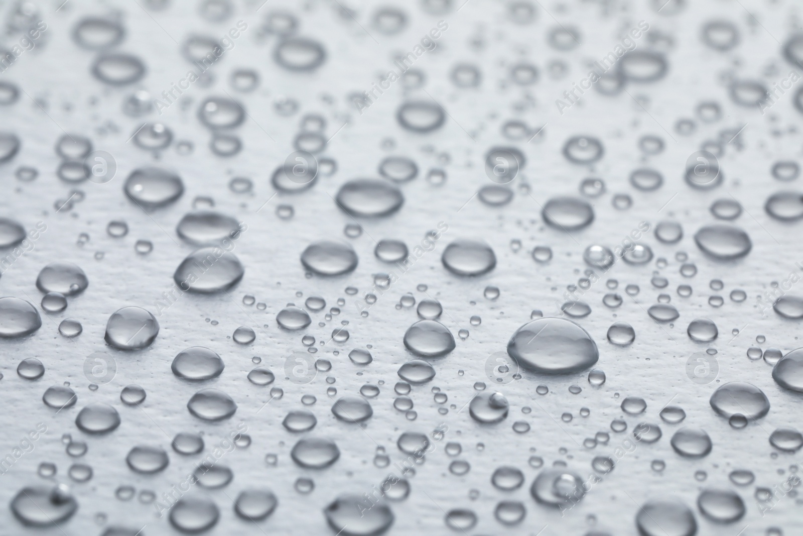 Photo of Water drops on white background, closeup view