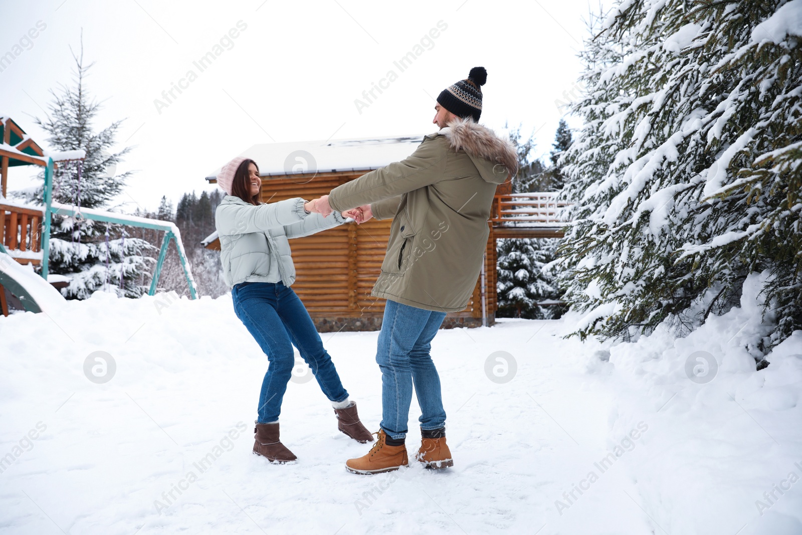 Photo of Lovely couple spending time together on snowy day. Winter vacation