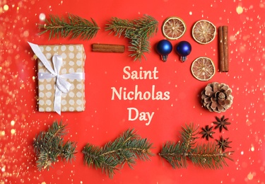 Saint Nicholas Day. Flat lay composition with Christmas decor on red background