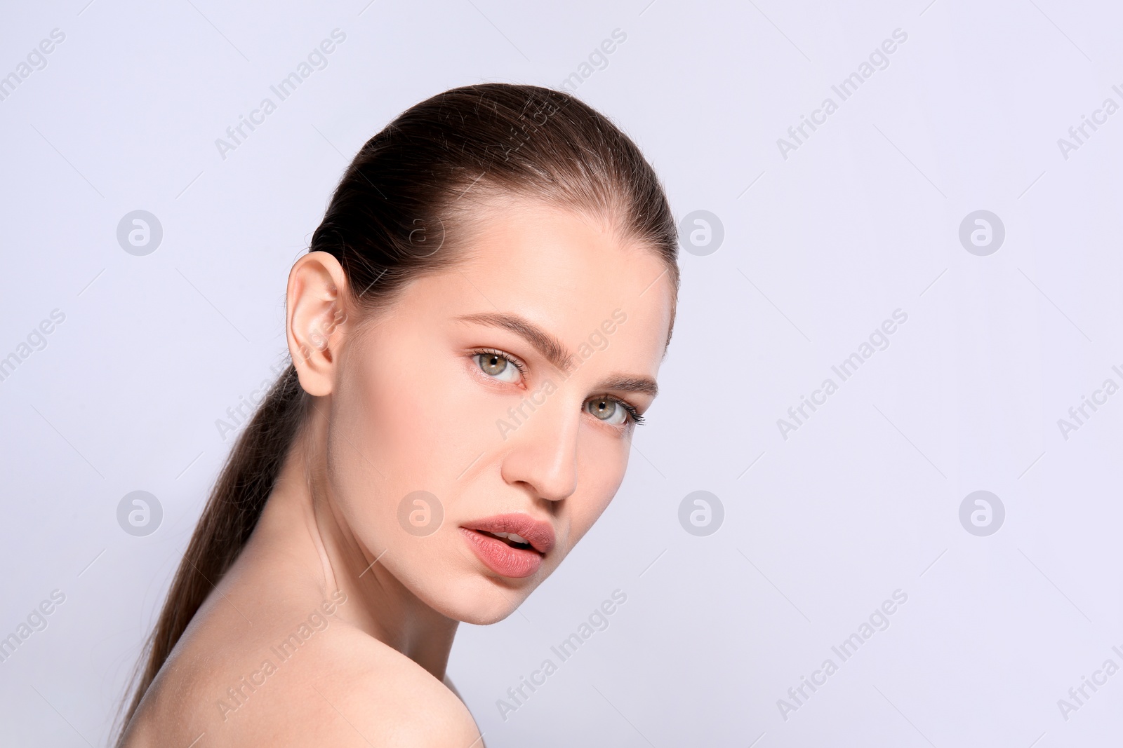 Photo of Beautiful woman with perfect eyebrows on light background