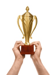 Young man holding gold trophy cup on white background, closeup