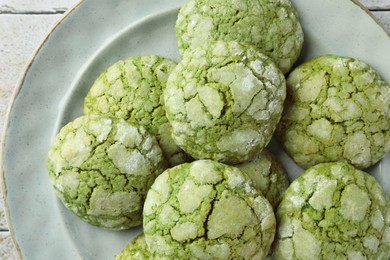 Plate with tasty matcha cookies on table, top view