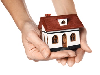 Woman holding house model in hands on white background