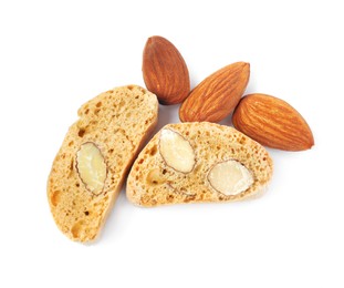 Photo of Slices of tasty cantucci and nuts on white background, top view. Traditional Italian almond biscuits