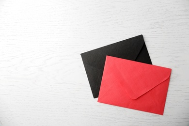 Paper envelopes on white wooden background, flat lay. Space for text