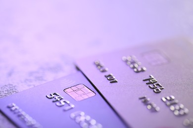 Photo of Plastic credit cards on table, closeup view. Color toned