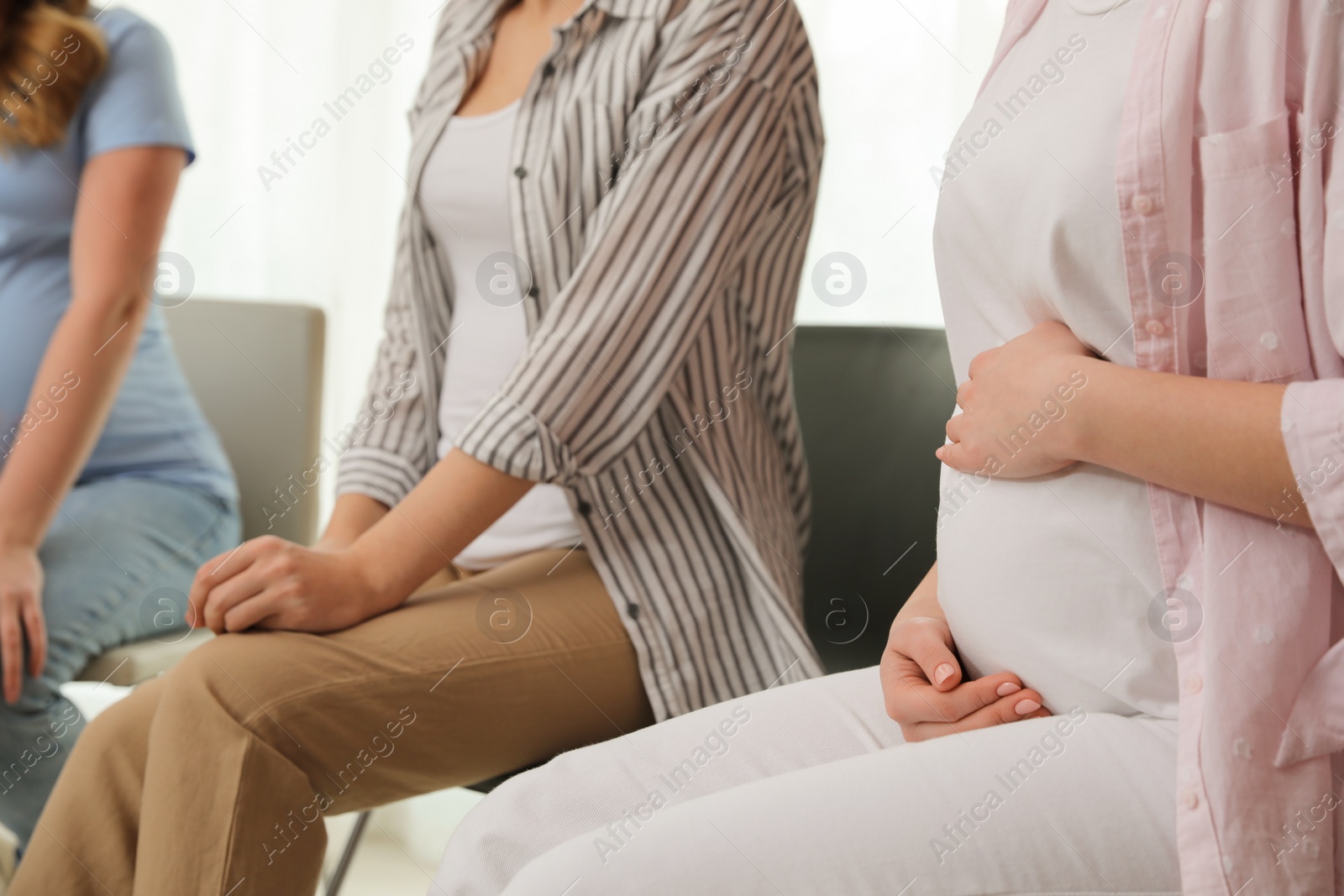 Photo of Group of pregnant women at courses for expectant mothers indoors, closeup