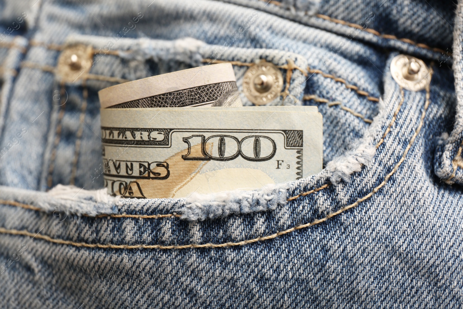 Photo of Dollar banknote in pocket of jeans, closeup. Spending money